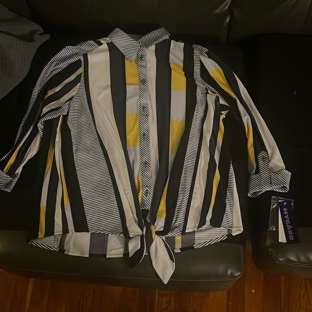 The white striped button down collar shirt tie at the waist
